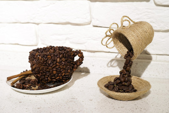 Cup of coffee with coffee beans on a beautiful brown background