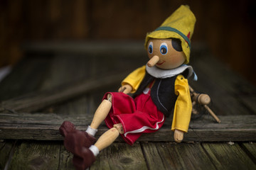 Old wooden pinocchio marionette toy . - obrazy, fototapety, plakaty