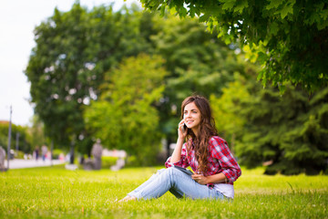 Sitting at the grass in park.