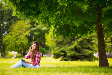 Phone woman laughing in talking in smart phone in park