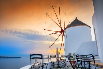 Windmill in Oia town at sunset. Santorini island, Greece