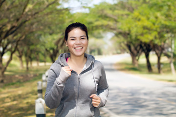 Running woman. Female runner jogging during outdoor on road .Young mixed race girl jogging in fall...