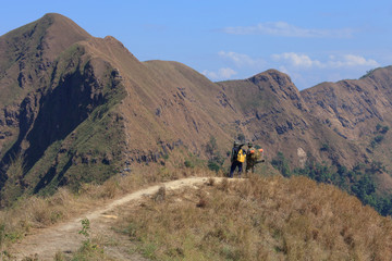 Obraz premium Group of trekkers are walking in mountain