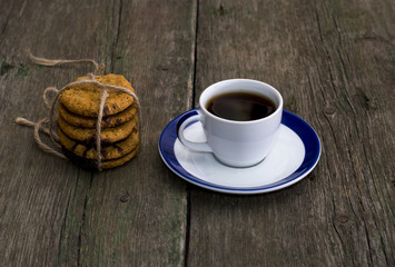 cup of coffee and nearby linking of oatmeal cookies