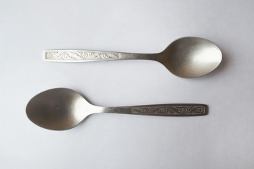 Two spoons on white background