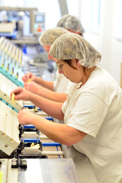 Workers on the assembly line of a chocolate factory