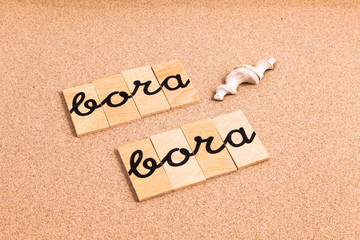 Words formed from small pieces of wood containing a sun and beach tourist destination, Bora Bora