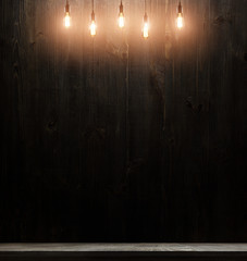 wooden interior room with classic Edison light bulb on wooden background switched on. retro edison...