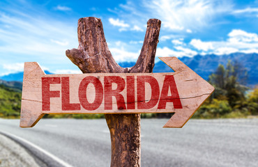 Florida wooden sign with road background