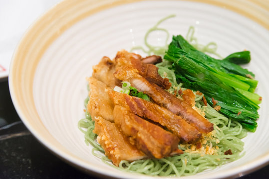 Jade noodle with crispy fried pork chinese hongkong  tradition f