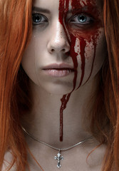 Girl with red hair, bloody face, a chain with a cross, blue eyes, vampire, murderer, psycho,...