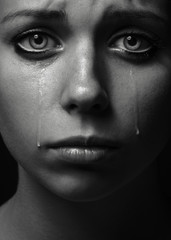 Violence and abuse of girls theme: portrait of a beautiful young girl with tears in her eyes, a beautiful sad girl in the studio - 85253923