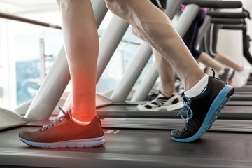Fototapeta na wymiar Highlighted ankle of man on treadmill