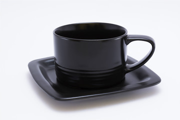 black cup and saucer isolated on white background