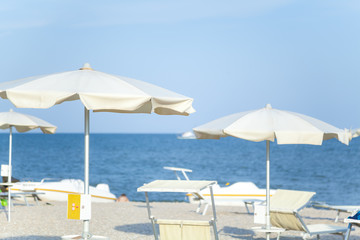 Fototapeta na wymiar Sun umbrellas on fashionable sea beach