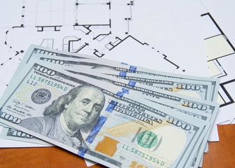 Money on house plan close-up