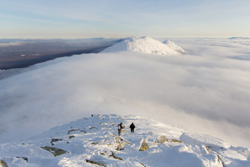 tourists descend from the mountains, a cloud passes over the mountain