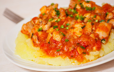 meat in tomato sauce with mashed potatoes
