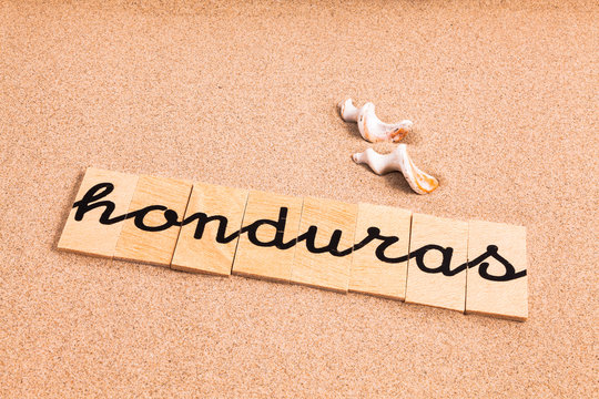 Words formed from small pieces of wood containing a sun and beach tourist destination, Honduras