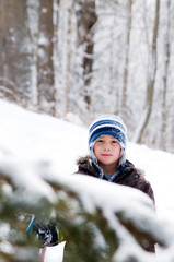 Fototapeta na wymiar young boy outdoors in winter clothing playing in the snow