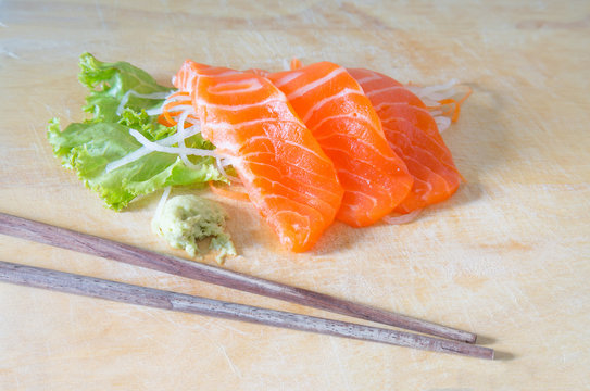 fresh sashimi saimon on wood background