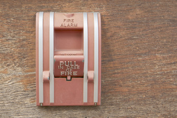 Old box of fire alarm on wood background