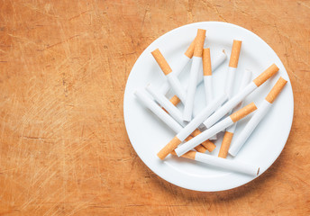 Cigarette on a plate top view