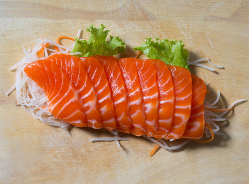 fresh sashimi saimon on wood background