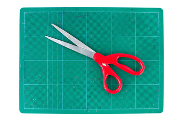 Green cutting mats with scissors on white background