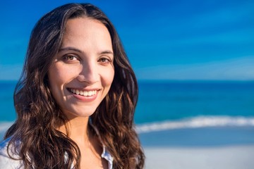 Smiling woman looking at camera at the beach 