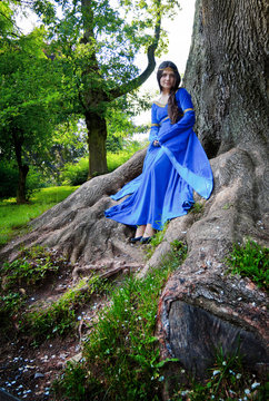 elf princess in roots of big tree