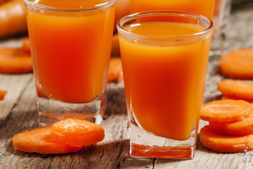 Fresh carrot juice in the glass, selective focus