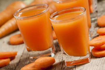 Fresh carrot juice in the glass, selective focus