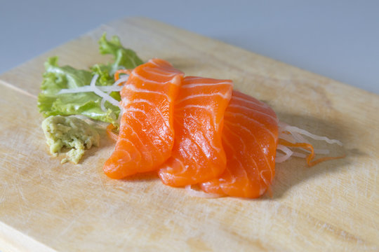 fresh sashimi saimon on wood background 