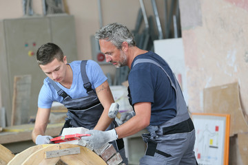 Teenager with professional brick layer in training school
