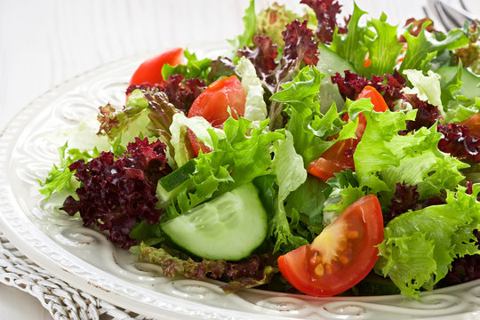 Salad with green, red lettuce, tomato and cucumber