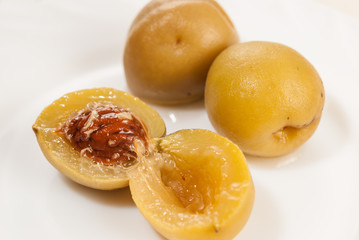 Delicious apricots from compote on white background