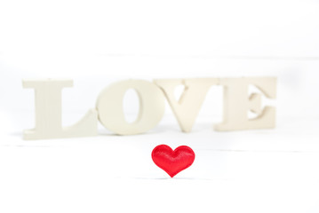 Word love with heart shaped on white wooden background. Valentines Day background