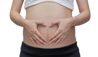 Pregnant woman forming heart out of her hands ,isolated against