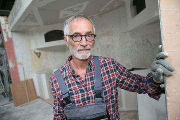 Portrait of senior craftsman in construction looking at camera