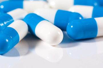 Background of blue and white capsule pills
