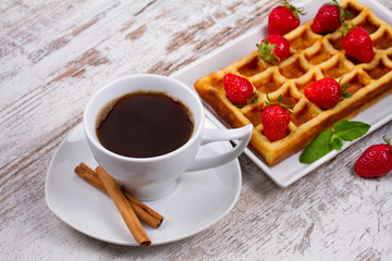 Cup of coffee, Belgium waffle and strawberries