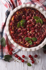 Clafoutis with cherry close-up vertical top view
