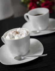 Photo of two coffee cups on a table