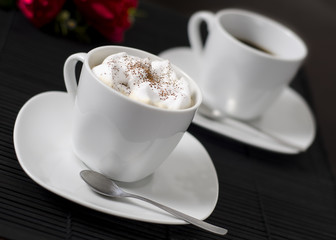 Photo of two coffee cups on a table