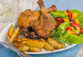 Duck leg with roasted potatoes and fruit salsa