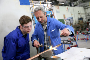 Teacher with student in metallurgy workshop