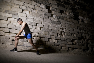 Young athlete warming in tunnel