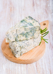 Blue cheese on wooden background