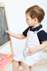 Child Drawing With Chalk